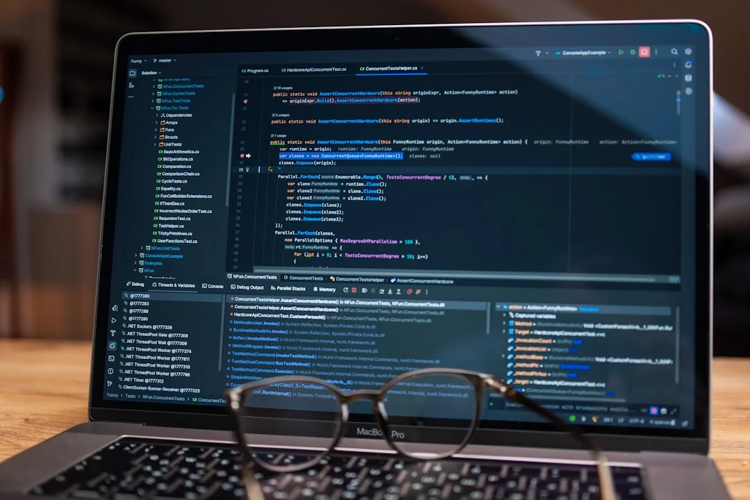 A modern workspace featuring dual computer monitors displaying web design projects, emphasizing technology and productivity.